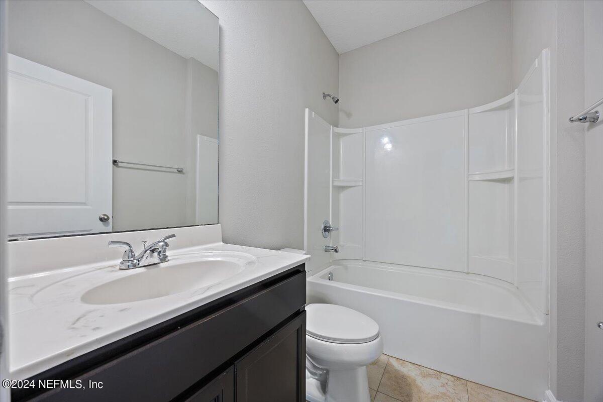 9802 Kevin Road Jacksonville, FL 32257 - Photo 6 of 23 a bathroom with a sink a toilet and bathtub