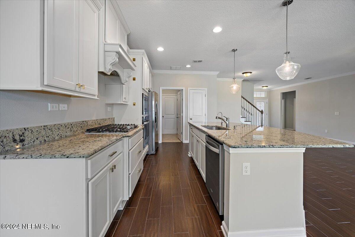 9802 Kevin Road Jacksonville, FL 32257 - Photo 10 of 23 a kitchen with granite countertop a sink a counter top space stainless steel appliances and cabinets