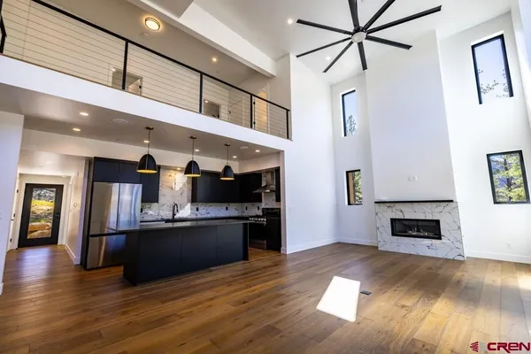 a kitchen with stainless steel appliances granite countertop a refrigerator a sink dishwasher a stove and a refrigerator