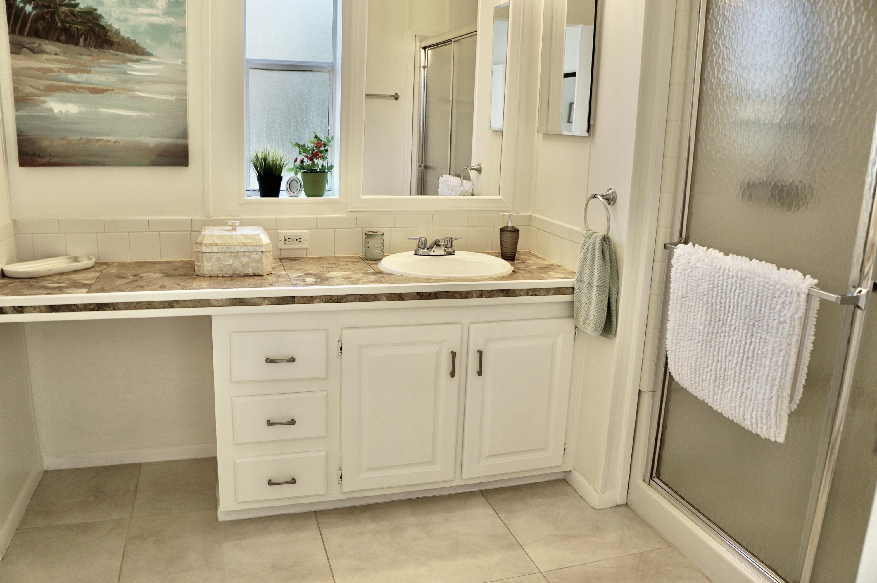 325 Mockingbird Avenue Fort Pierce, FL 34982 - Photo 16 of 39 a bathroom with a granite countertop sink and a mirror