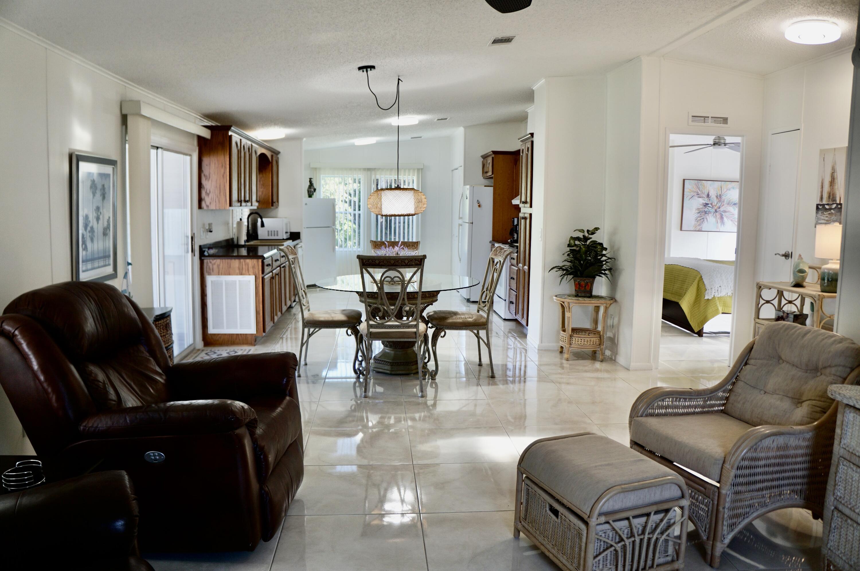 325 Mockingbird Avenue Fort Pierce, FL 34982 - Photo 5 of 39 a living room with furniture and a chandelier