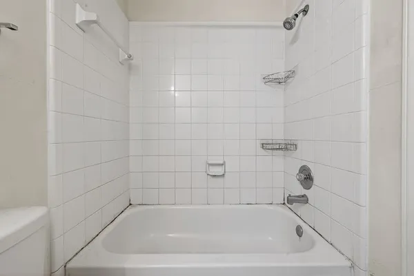 a bath tub sitting next to a shower