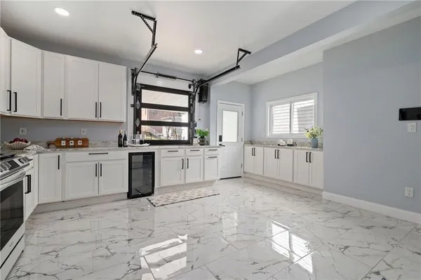 a kitchen with white cabinets and white appliances