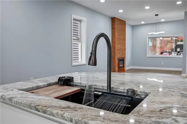 a kitchen with granite countertop a stove and a sink