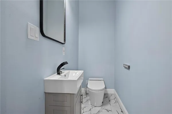 a bathroom with a sink a mirror and toilet