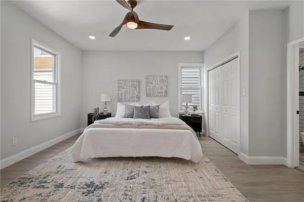 a bedroom with a large bed and a window