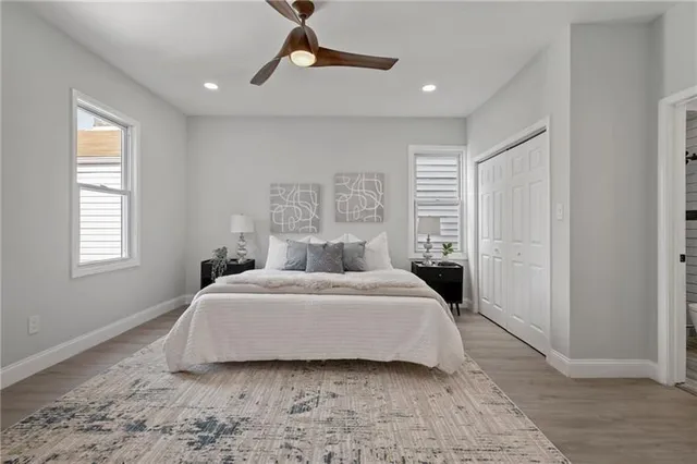 a bedroom with a large bed and a window