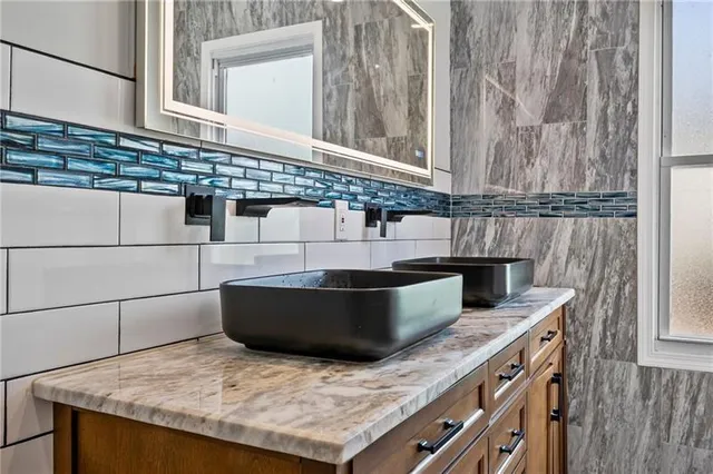 a kitchen with granite countertop a sink and a stove