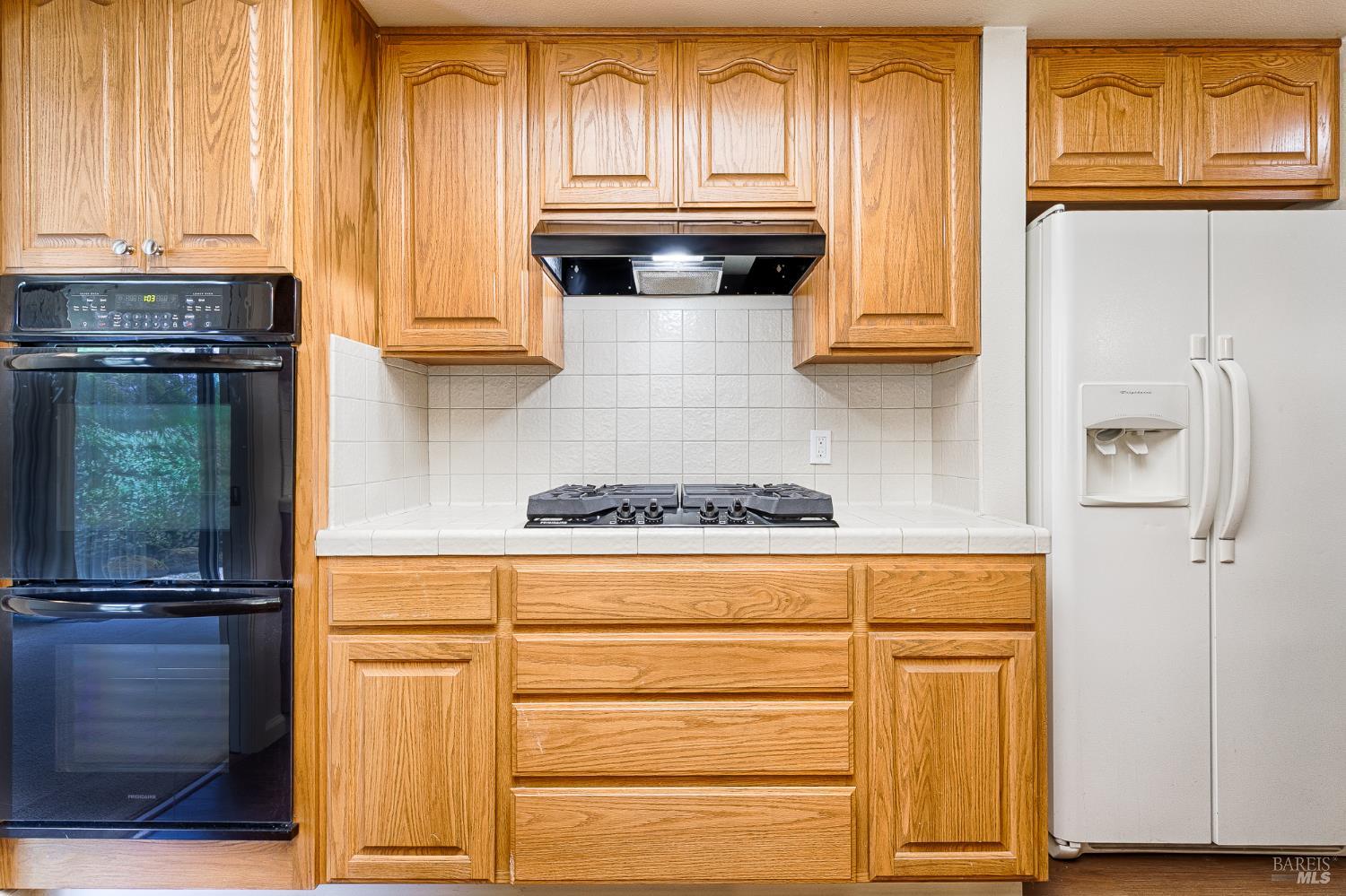 138 Oak Shadow Drive Santa Rosa, CA 95409 - Photo 18 of 50 a stove top oven sitting inside of a kitchen