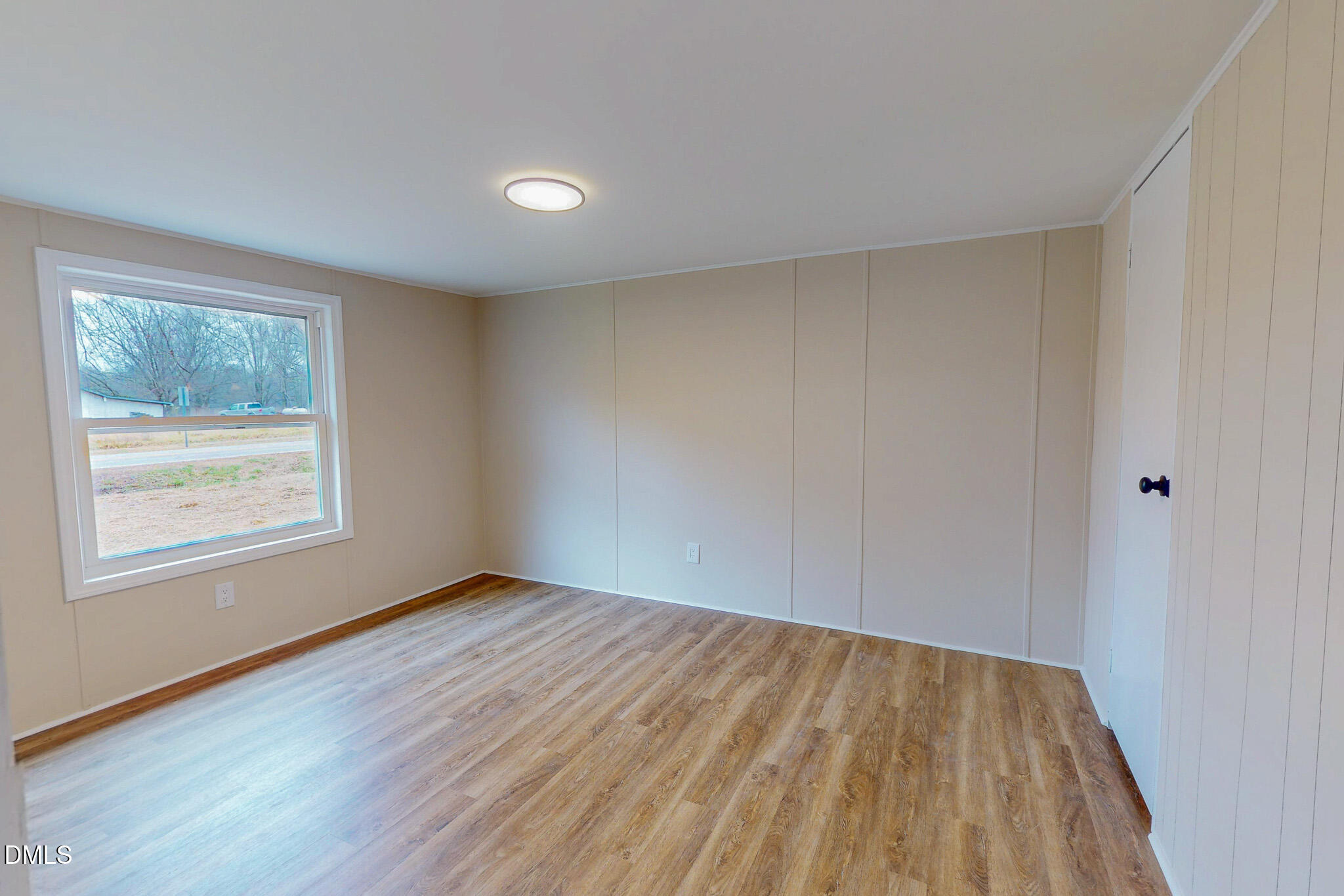 67 Halifax Road Roxboro, NC 27574 - Photo 44 of 48 an empty room with wooden floor and windows