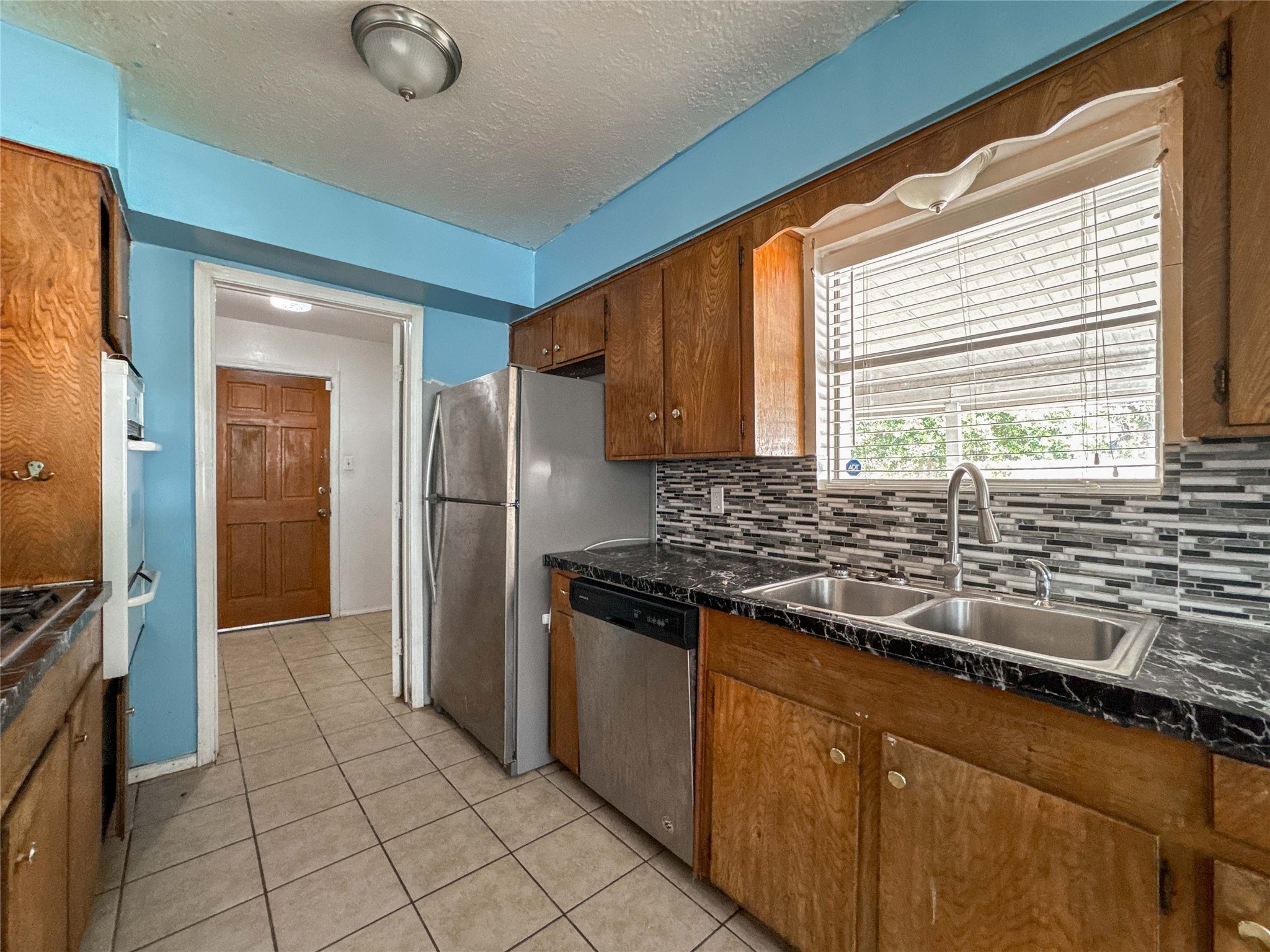 4522 Sage Circle Baytown, TX 77521 - Photo 12 of 33 a kitchen with granite countertop a sink stainless steel appliances and cabinets