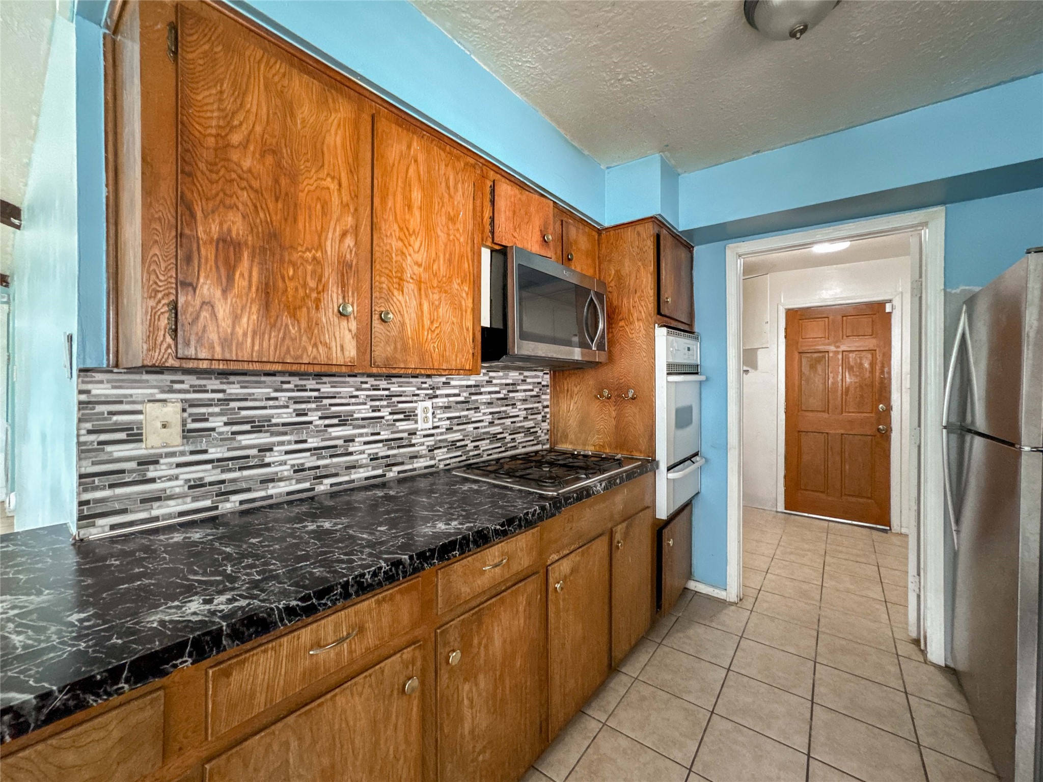 4522 Sage Circle Baytown, TX 77521 - Photo 13 of 33 a kitchen with stainless steel appliances granite countertop a refrigerator and a sink