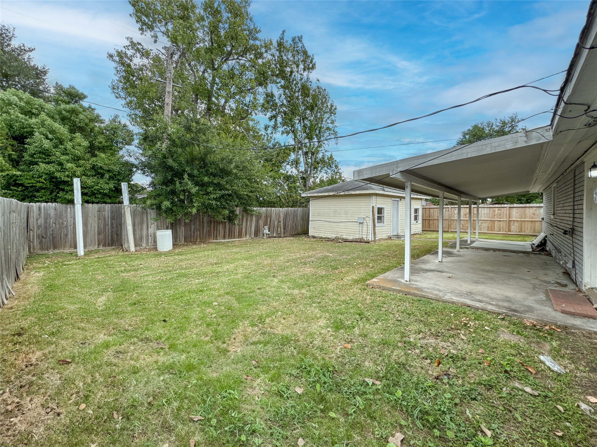 4522 Sage Circle Baytown, TX 77521 - Photo 28 of 33 a backyard of a house with a large tree