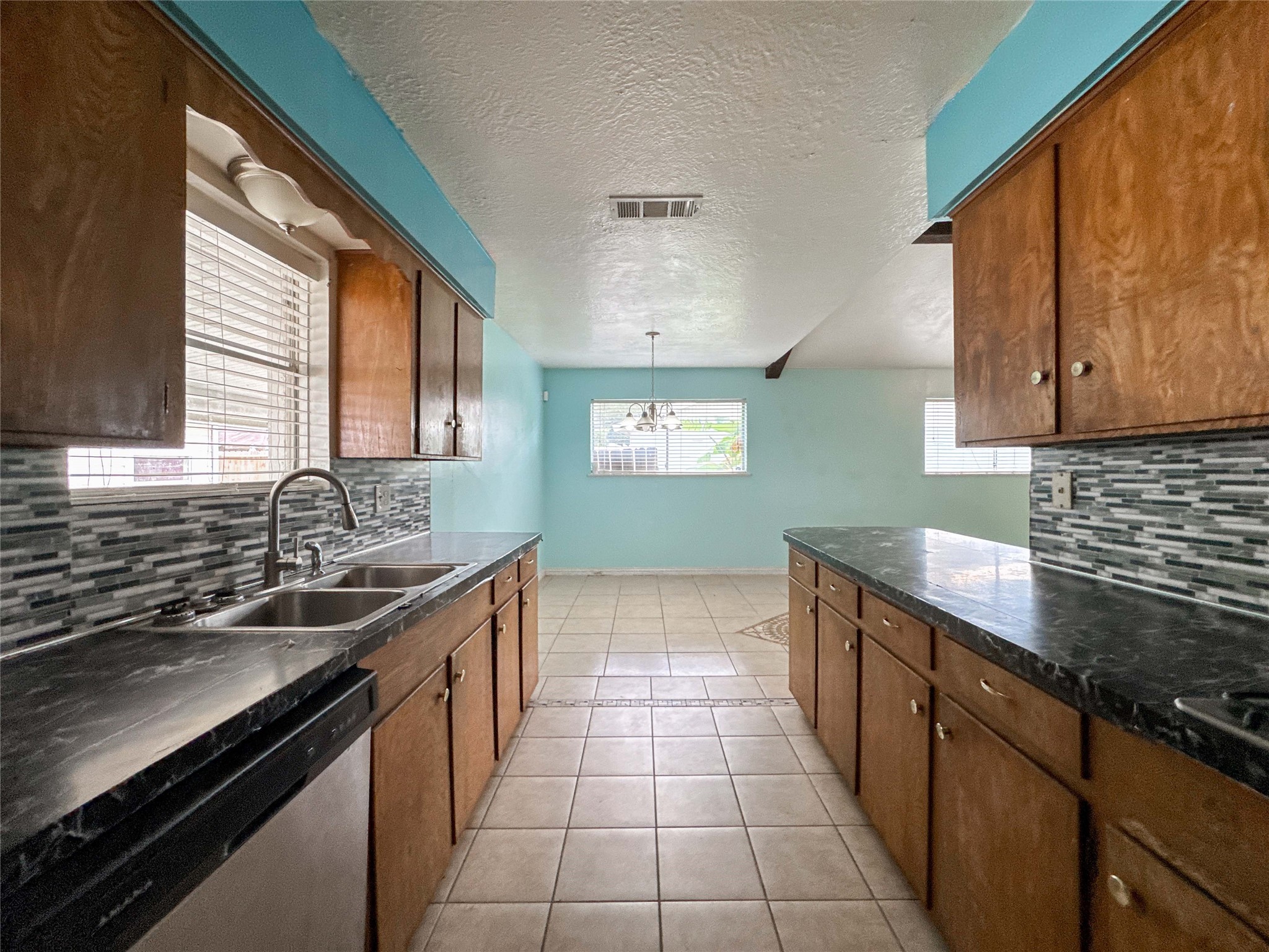 4522 Sage Circle Baytown, TX 77521 - Photo 10 of 33 a kitchen with a sink and a stove