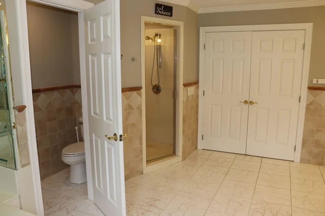 a view of a bathroom with a shower and a toilet