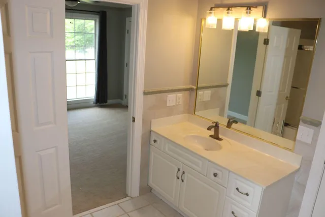 a bathroom with a double vanity sink and a mirror