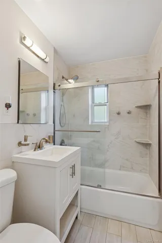 a bathroom with a double vanity sink mirror toilet and bathtub