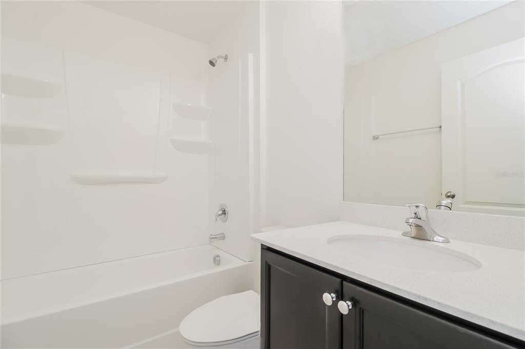 1187 Moyle Way Mascotte, FL 34753 - Photo 14 of 16 a bathroom with a sink and a mirror