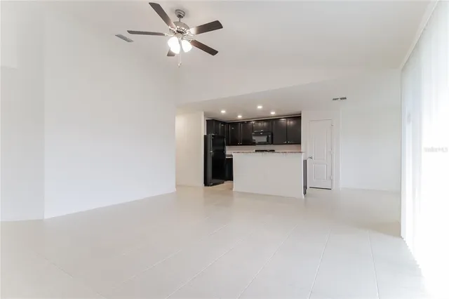 a view of a kitchen with a sink and a refrigerator