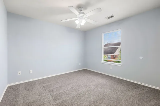 a bathroom with a toilet a sink a mirror and a shower