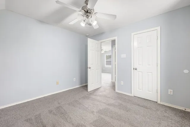 a view of a house with a big yard and a large tree