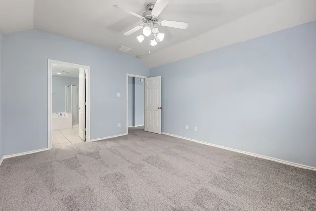 a bathroom with a sink double vanity granite tub shower and a mirror