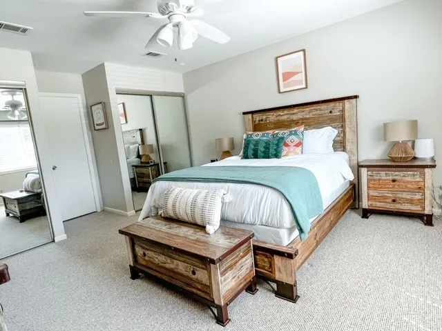 a bedroom with a bed and a chandelier
