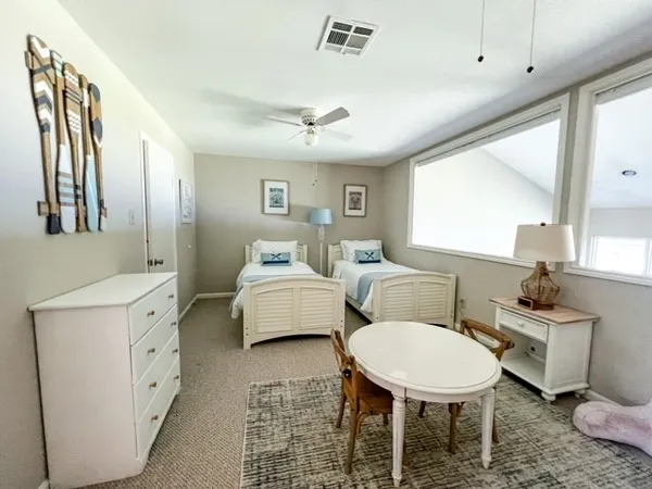 a hotel room with two beds and a chandelier