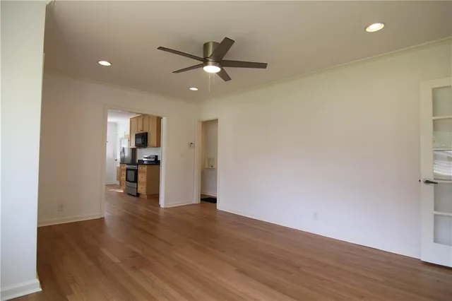a view of empty room with wooden floor