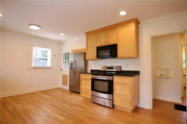 a kitchen with stainless steel appliances granite countertop a stove and a refrigerator