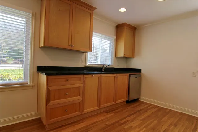 a kitchen with granite countertop wooden cabinets and a sink