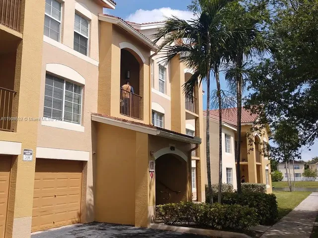 a view of a house with a palm tree