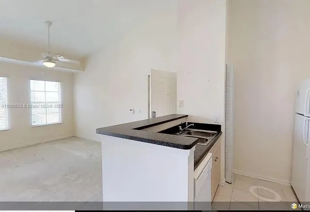 a kitchen that has a sink and a stove top oven