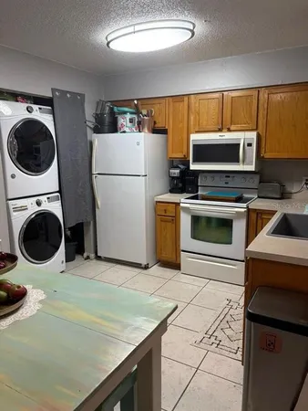 a kitchen with a stove a microwave and refrigerator