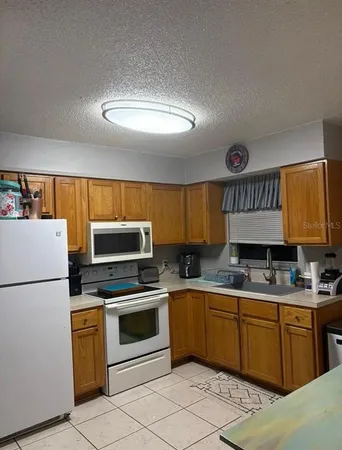 a kitchen with a sink appliances and cabinets