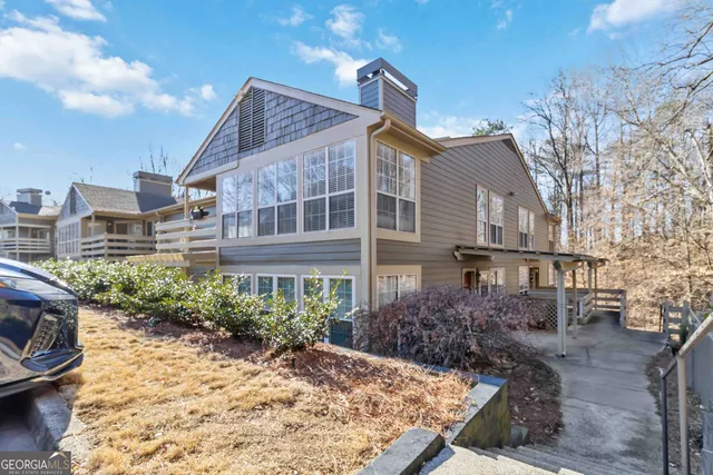 a view of a house with a yard and sitting area