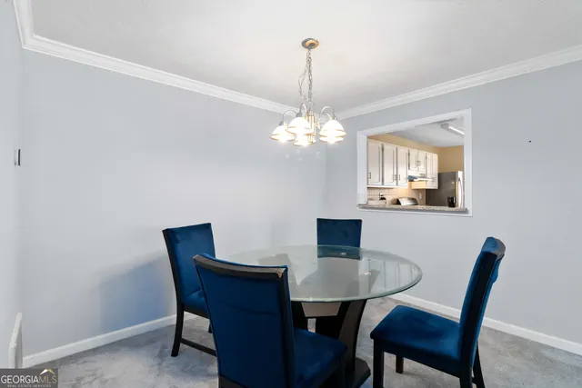 a view of a dining room with a table and chairs
