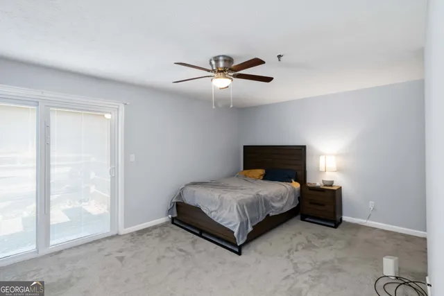 a bedroom with a bed and large glass window