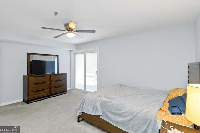 a bedroom with a bed and a ceiling fan
