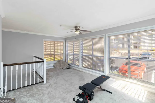 a living room with furniture and floor to ceiling windows
