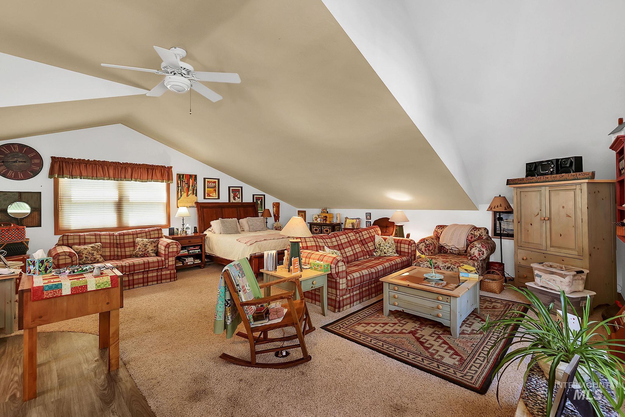 1345 Divot Lane McCall, ID 83638 - Photo 12 of 13 Spacious room with sloped ceilings and a ceiling fan