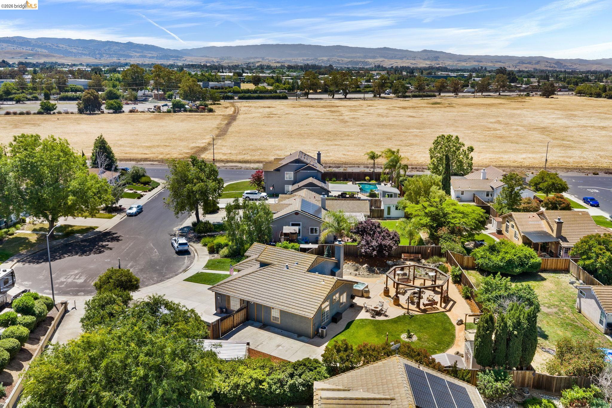 1186 El Rio Court Livermore, CA 94551 - Photo 52 of 60 Expansive backyard featuring a manicured lawn, a circular pergola, a paved patio, and mature landscaping