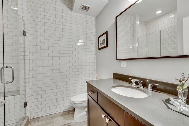 33 North Morgan Street, Unit 3 Chicago, IL 60607 - Photo 14 of 15 a bathroom with a sink a toilet and mirror