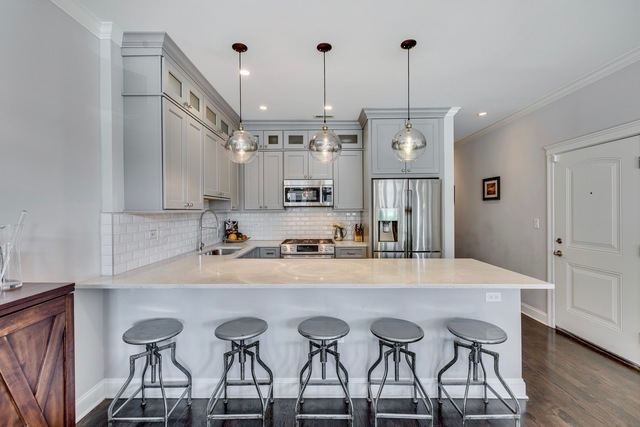 33 North Morgan Street, Unit 3 Chicago, IL 60607 - Photo 6 of 15 a view of kitchen island with furniture and wooden floor