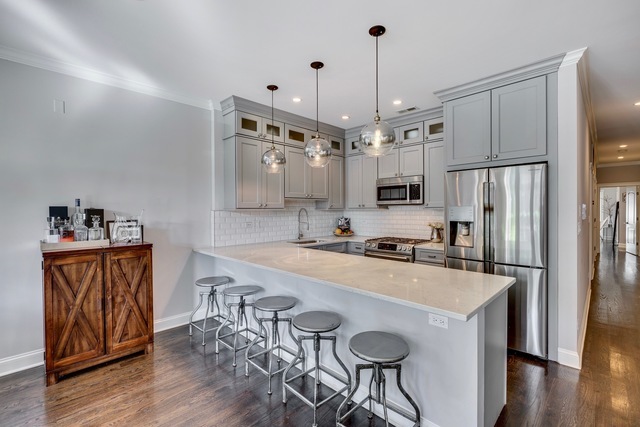 33 North Morgan Street, Unit 3 Chicago, IL 60607 - Photo 7 of 15 a kitchen with granite countertop a table chairs stove and refrigerator