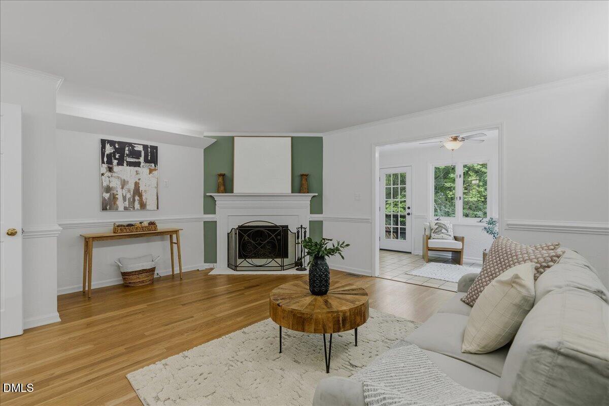 2834 Wayland Drive Raleigh, NC 27608 - Photo 1 of 26 a living room with furniture a fireplace and a table