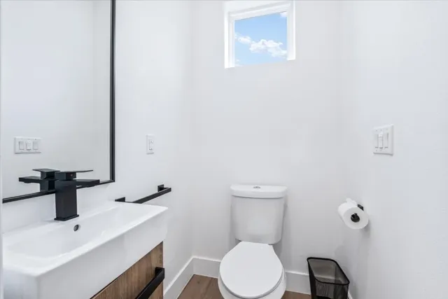 a white toilet sitting next to a bathroom sink