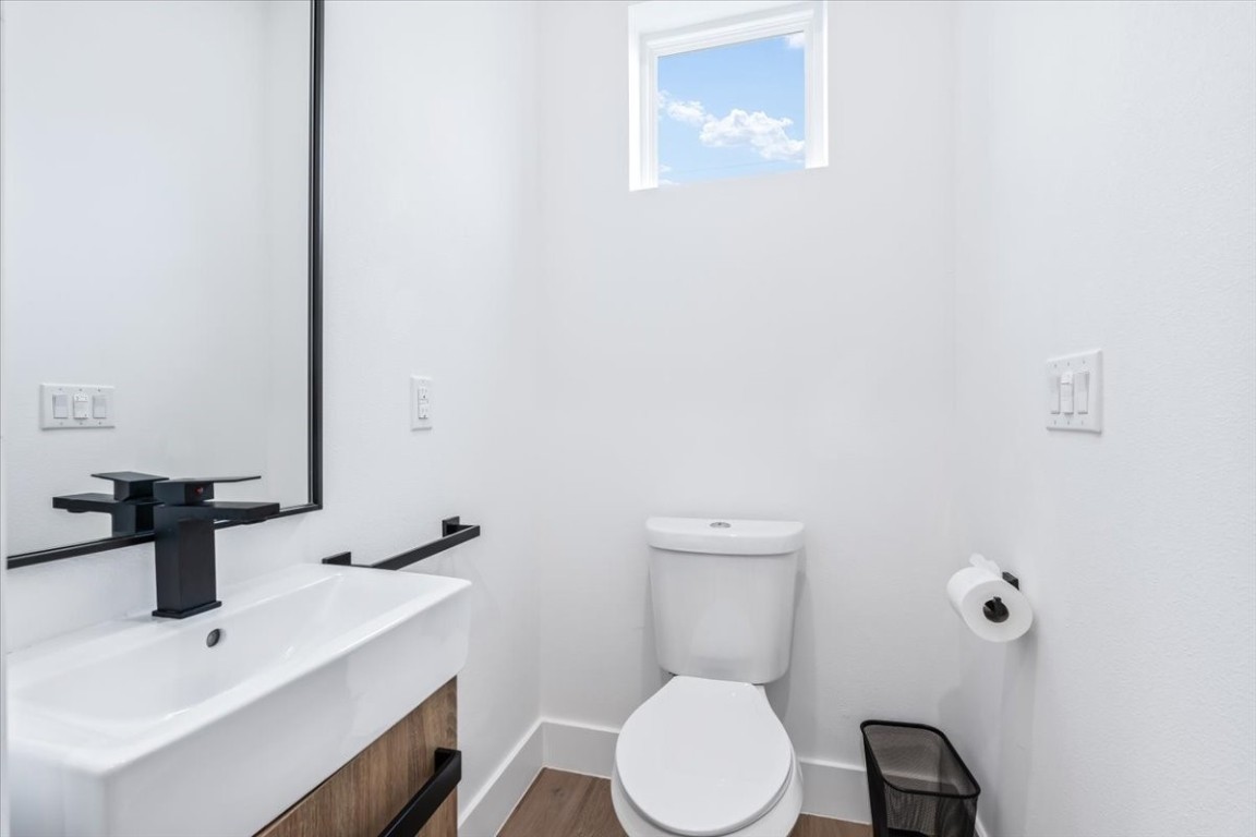 6300 Santos Street, Unit 3 Austin, TX 78741 - Photo 12 of 32 a white toilet sitting next to a bathroom sink