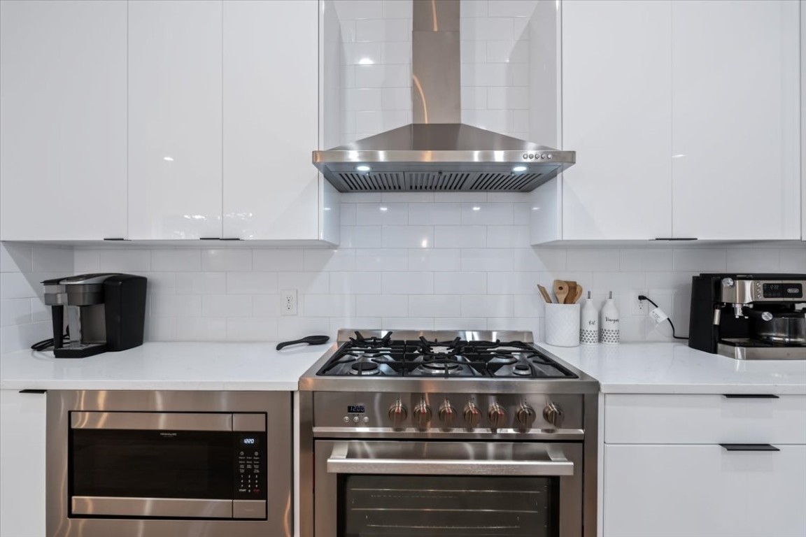 6300 Santos Street, Unit 3 Austin, TX 78741 - Photo 16 of 32 a kitchen with a stove and a white cabinets