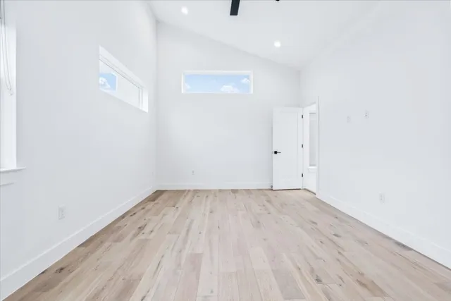 a view of an empty room with wooden floor